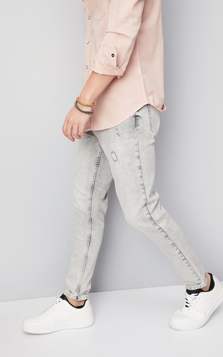 Buy Men Distressed Carrot Fit Jeans Online at just