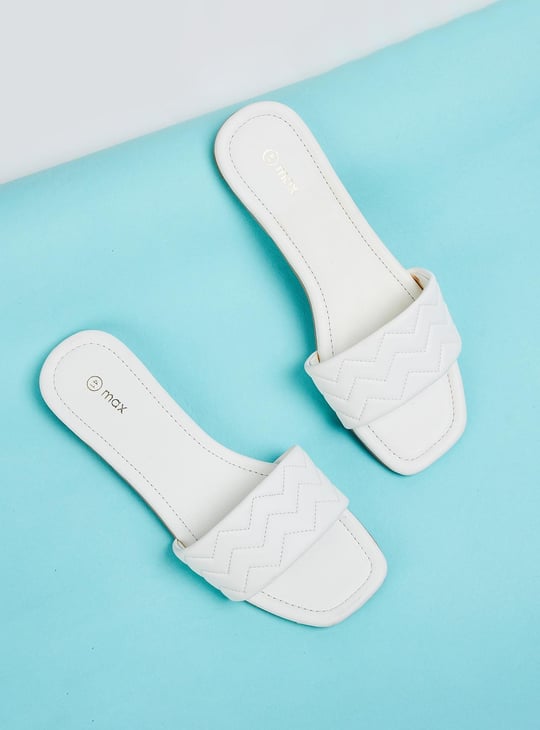 white plastic flat sandals