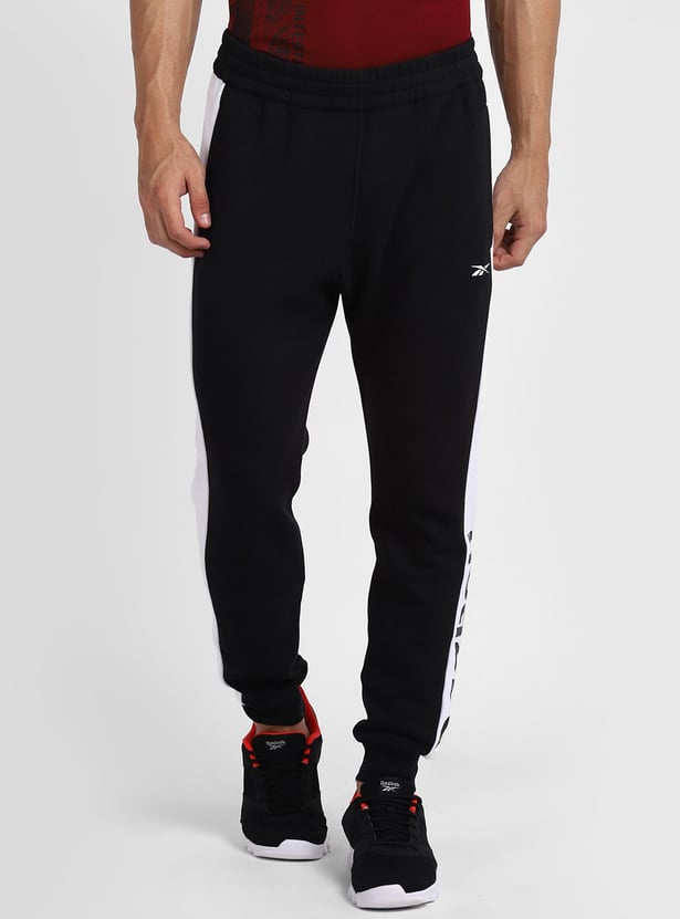Buy REEBOK Men Printed Full-Length Regular Fit Track Pants from
