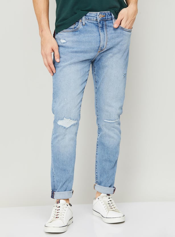 Buy FLYING MACHINE Men Slim Tapered Distressed Jeans from Flying