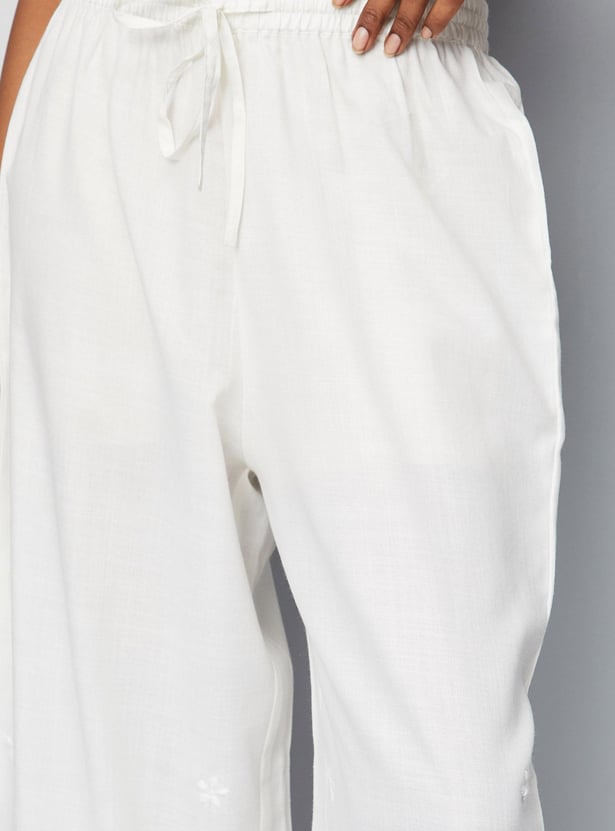 Women Solid Palazzos with Schiffli Detail